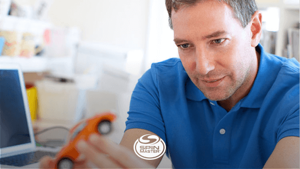 Man examining a toy car