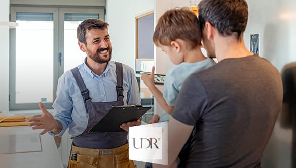 Technician speaking to man and son.