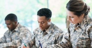 Three military personals are writing