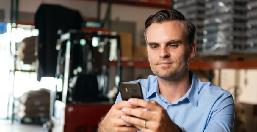 Man looks at his phone.
