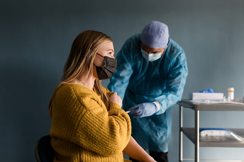A woman gets a dose of the Covid vaccine