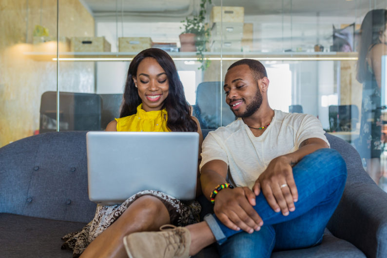 Black Woman and Man working on a laptop