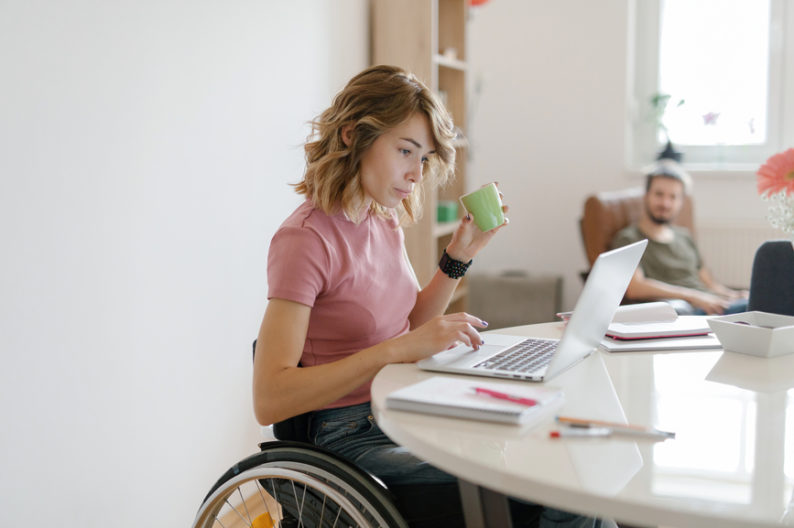 Disabled woman works from home in wheelchair