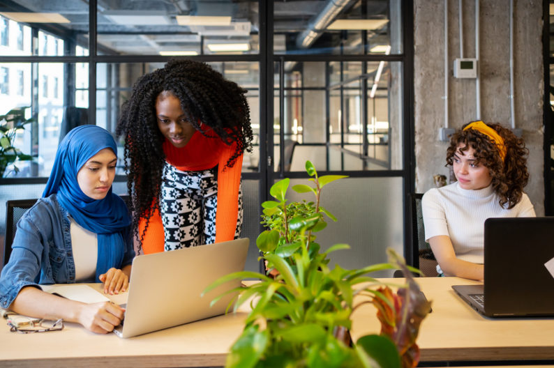 In the middle of the tightest labor market on record, women work together in an office.