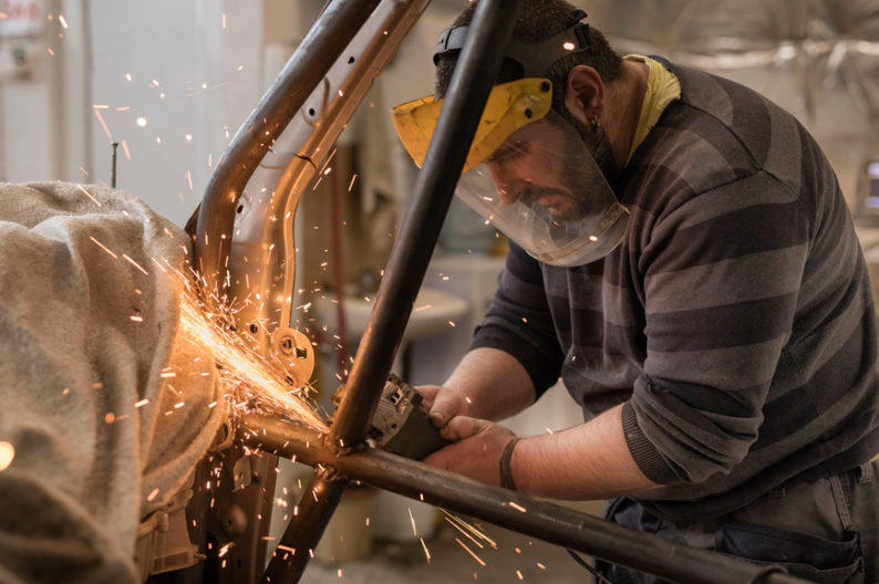 Car manufacturing job being done by employee