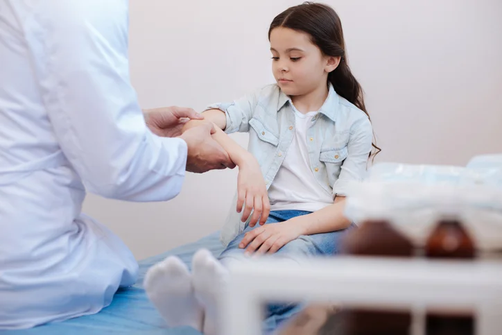 school nurse checking on student arm