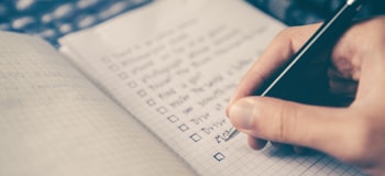 Person writing a checklist